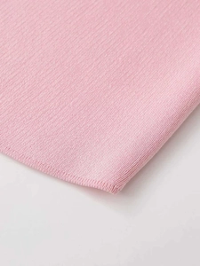 Close-up of pink knit fabric showing detailed horizontal weave texture and soft pastel color
