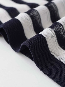 Close-up detail of high-quality navy blue and white striped knit fabric texture