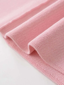 Macro shot of soft pink knit fabric texture and high-quality vertical ribbed details