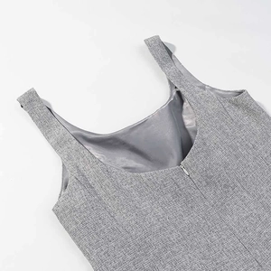 Detail of grey textured tweed fabric with seamless hidden back zipper and inner lining