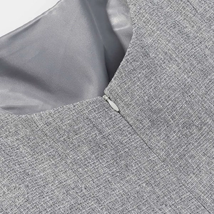 Detail of invisible zipper on grey textured blazer and smooth satin inner lining fabric