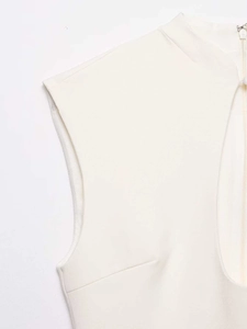 Detail view of white sleeveless dress with mock neck and textured fabric finish