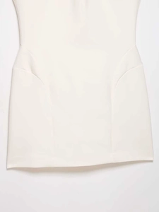Detailed view of the hollow waist cut-out and premium texture of a white sleeveless dress