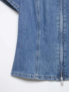 Detail of blue denim shirt with silver metal zipper and structural double stitching