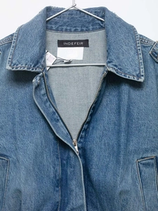 Close-up of vintage blue denim jacket with zipper closure and classic lapel collar