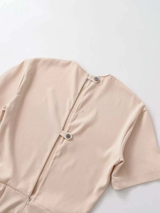 Detail view of beige midi dress back with slit closure, buttons, and invisible zipper