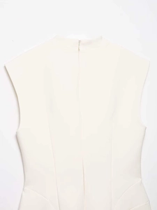 Detail shot of the back invisible zipper and fitted seams on white sleeveless dress