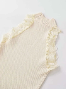 Detail of cream rib-knit vest featuring high neck and delicate floral lace armhole trim
