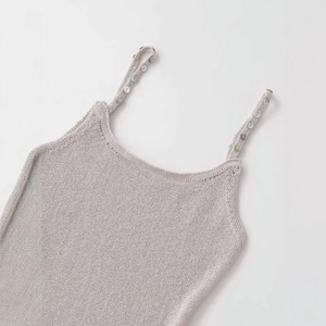 Minimalist oatmeal knit tank top with iridescent buttons and thin shoulder straps