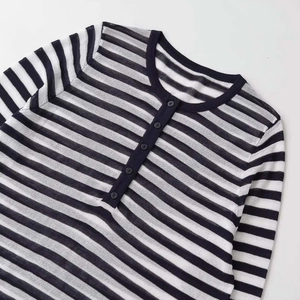 Navy and white striped Henley knit sweater with long sleeves and buttoned collar detail