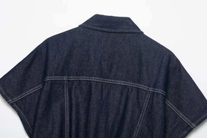 Detail of dark blue denim shirt dress back with contrast white stitching and sharp collar