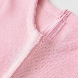 Pink slim fit knit top with stylish puff sleeves and a back zipper closure detail