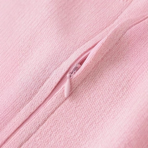 Pink knit top with matching invisible zipper detail and soft ribbed fabric texture