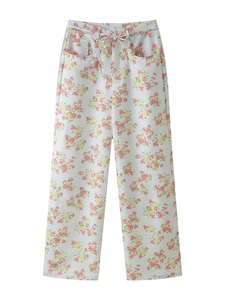 Detail of floral wide-leg trousers in beige with high waist and drawstring tie