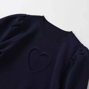 Navy puff sleeve knit sweater featuring a stylish heart-shaped cutout and crew neck design