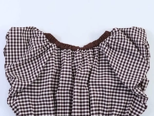 Detail of vintage brown gingham top showing elastic V-neckline and puffed sleeve texture