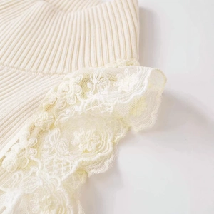 Elegant cream knit halter top featuring ribbed texture and delicate floral lace trim