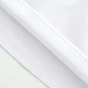 Detailed macro shot of white cotton blouse hem featuring precise stitching and clean folded edges