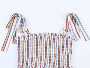 Detail of colorful striped camisole top featuring smocked elastic bodice and bow shoulder straps