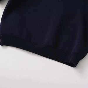 Dark navy puff sleeve knit top featuring a heart cut-out design and ribbed hemline