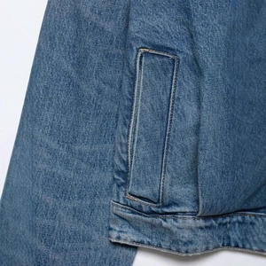 Retro blue cropped denim jacket featuring side pockets and detailed wash finish