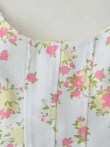 Close-up of floral print fabric showing neat stitching on a summer wide-leg set