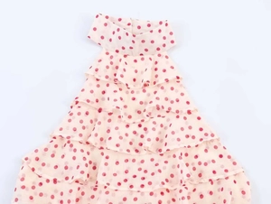 Close-up of pink polka dot georgette halter top with layered ruffle hem detail