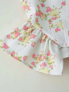 Detail shot of summer floral print set showing ruffle edges and high-quality cotton fabric