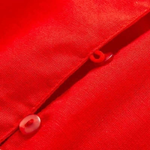 Detail of red ruffle sleeve shirt fabric showing texture and matching round buttons