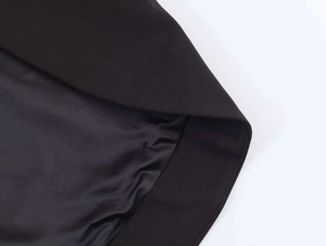 Detail of elegant black suit showing neat stitching and silky satin inner lining texture