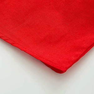 Detail shot of bright red ruffle sleeve shirt fabric with professional hemmed edges