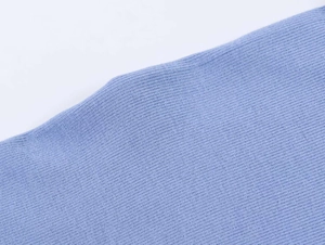 Macro detail of the fine knit texture and light blue fabric of the casual T-shirt