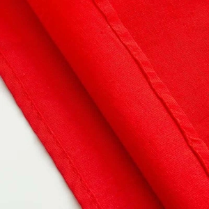 Macro detail of red ruffled shirt fabric showing precise stitching and textile texture