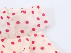 Detail of polka dot georgette halter top with stand-up collar and smooth stitching