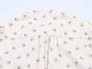 Close-up of the back stand collar and gathered pleats on the floral print blouse