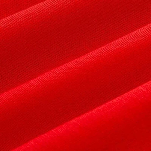 Detailed macro view of the soft red knitted fabric with smooth fine grain texture