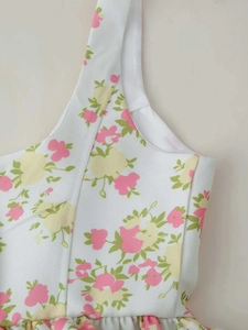 Detailed close-up of floral print straps and neckline on summer wide-leg jumpsuit
