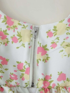 Detail of silver metal zipper on summer floral print wide leg pant set fabric