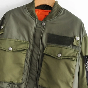 Army green flight bomber jacket featuring orange lining and functional utility pockets