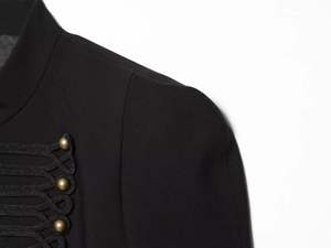 Close-up of black blazer with intricate braided frogging and gold spherical metal buttons