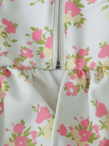 Detail of floral print fabric with metal zipper closure and gathered waist structure