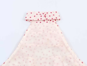 Close-up of semi-transparent georgette halter top with red polka dots and collar buttons