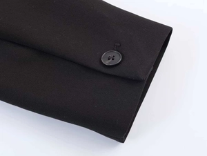 Detail of a black suit jacket cuff featuring a single button and fine woven fabric texture