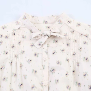 Floral stand collar shirt with bow tie detail and pleated design in a light summer style