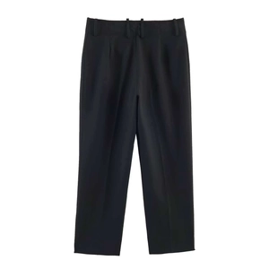 Detail of high-waist black tailored trousers with straight leg cut and smooth texture