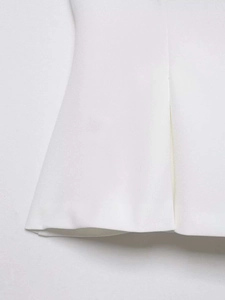 Close-up of white vest fabric texture and detailed hem stitching for a minimalist style