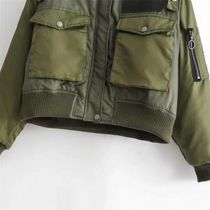 Close-up of army green bomber jacket with utility pockets and rib-knit hem detail