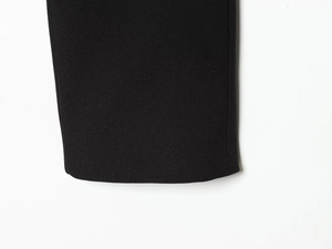 Close-up of high-quality black fabric texture and neat stitching on blazer hem