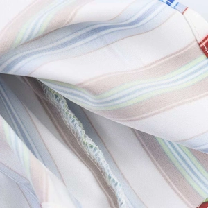 Close-up of internal stitching on a multicolored striped honeycomb fabric summer camisole