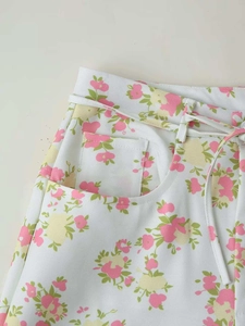 Detail shot of floral print fabric with waist drawstring and pocket on wide-leg pants